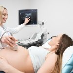 doctor-doing-ultrasound-exam-pregnant-woman-s-abdomen