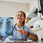 overjoyed-female-physician-telling-diagnosis-with-chest-x-ray
